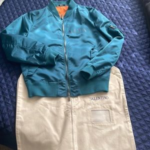 Mens VLTN bomber jacket circa 2019. Teal color, orange lining.